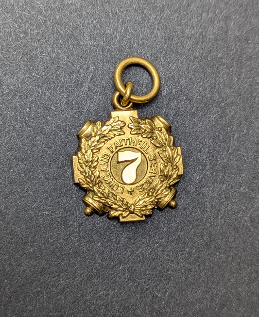 Tiffany + Co 1895 18k "7" Badge Charm