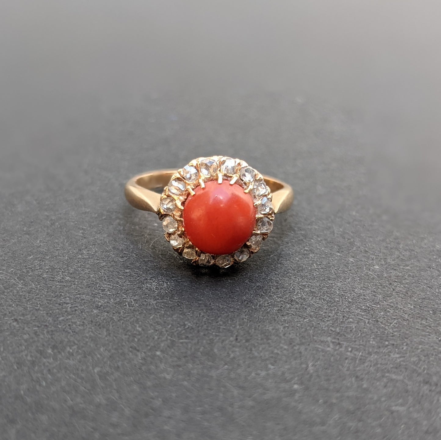 18k Ring with coral and a mine cut diamond halo