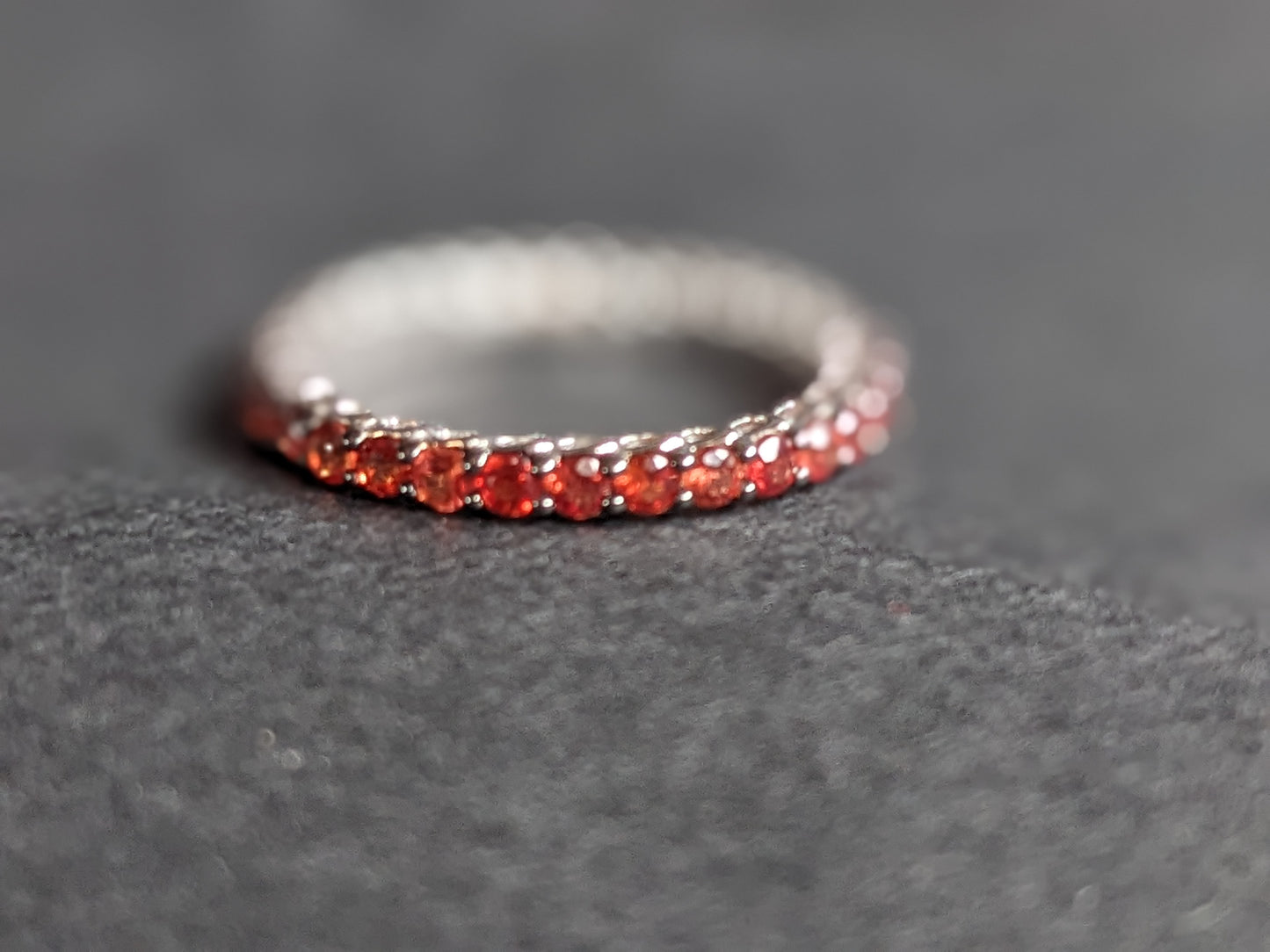 White gold & burnt orange sapphire eternity band 18k