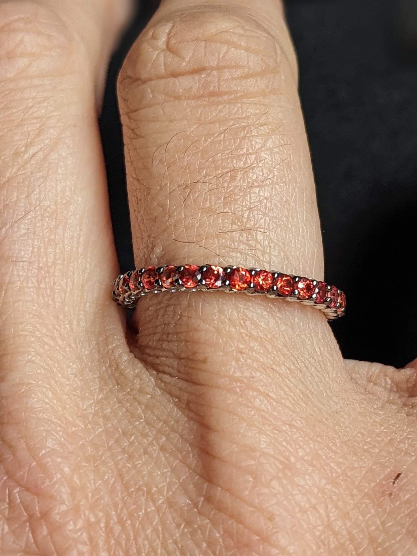 White gold & burnt orange sapphire eternity band 18k