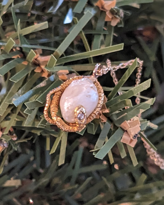 Natural pearl wrapped in snake with diamond head