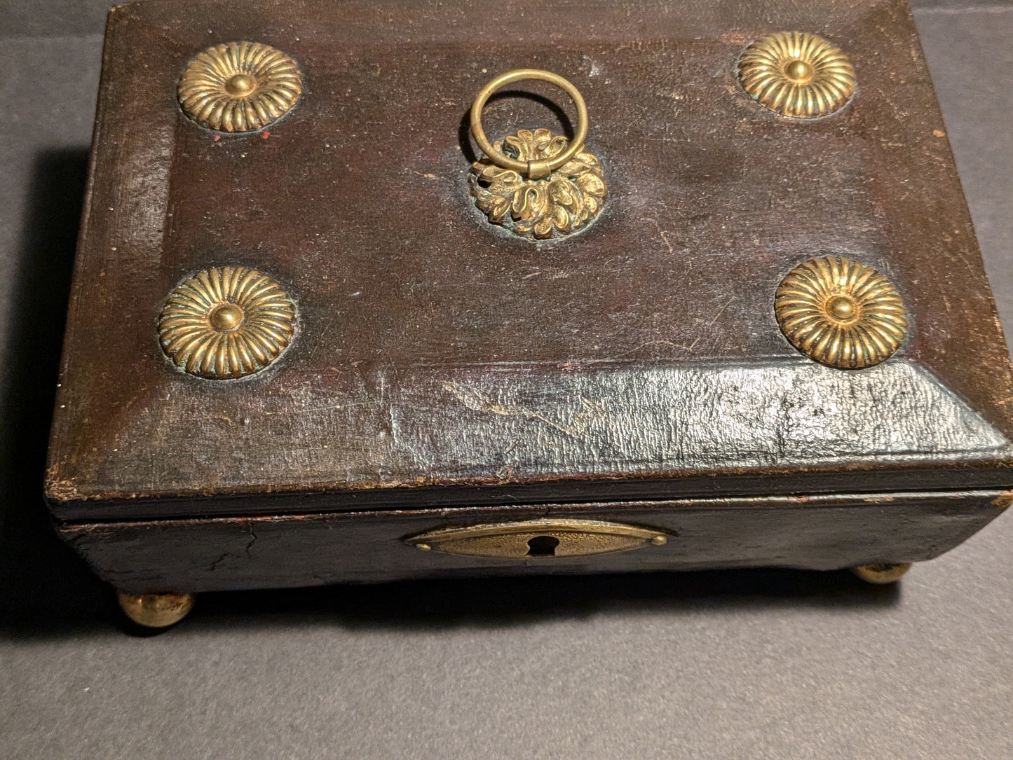 Brown wood jewelry box with gold adornment