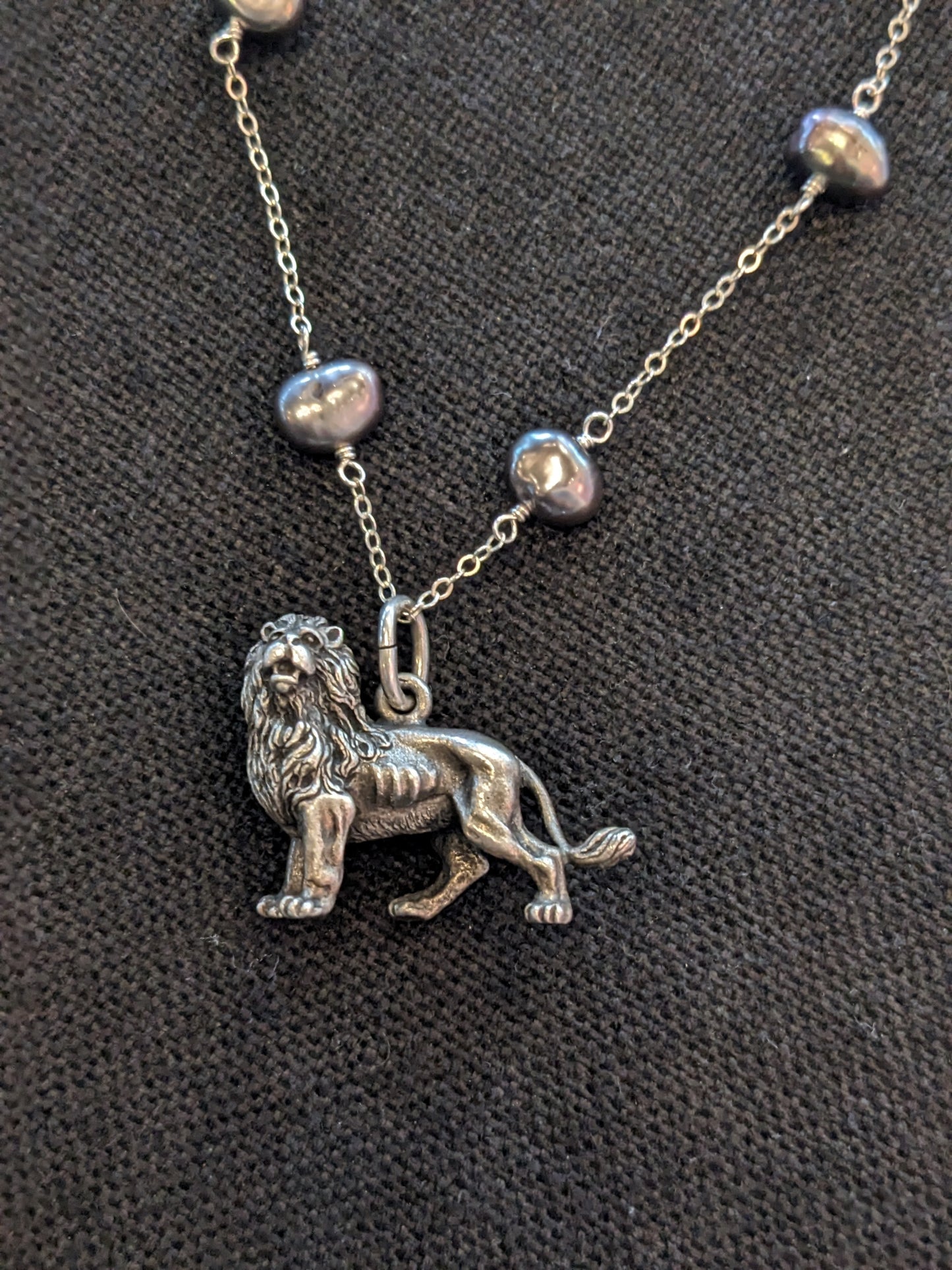 Large silver lion on grey pearl necklace