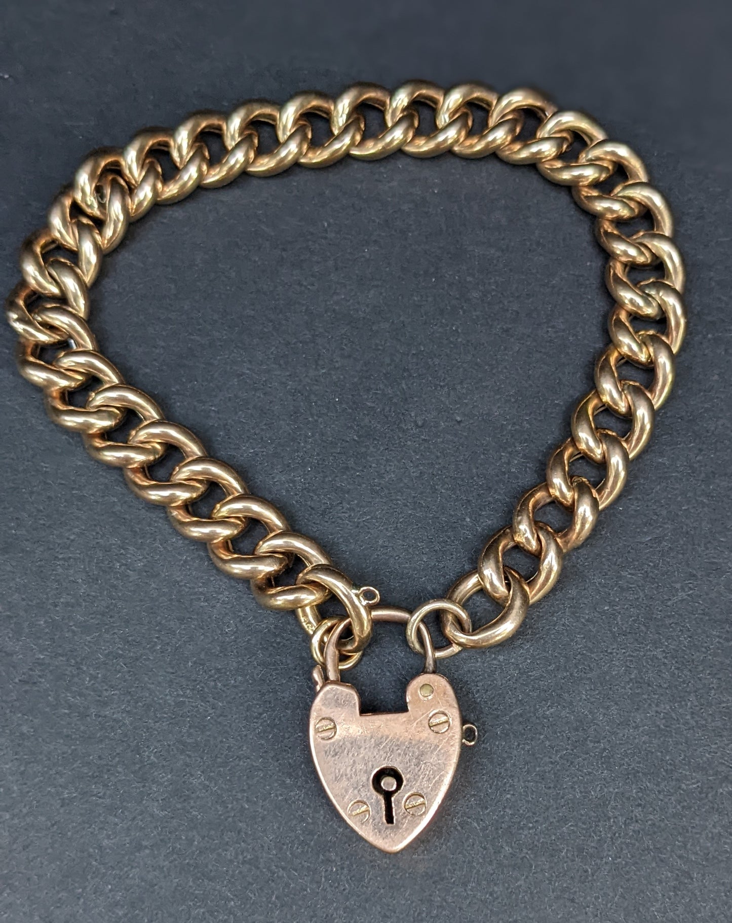 Heavy curb chain bracelet with heart padlock clasp