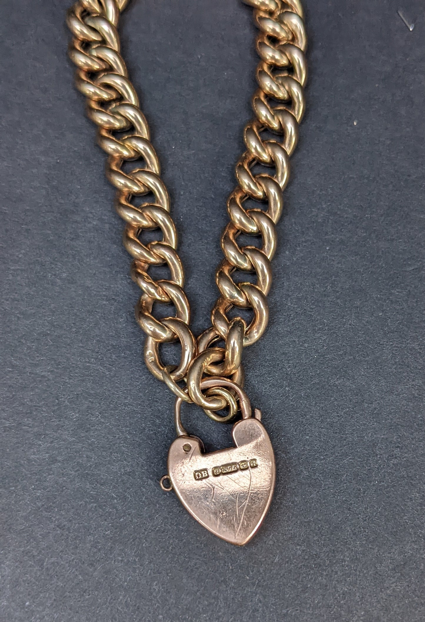 Heavy curb chain bracelet with heart padlock clasp