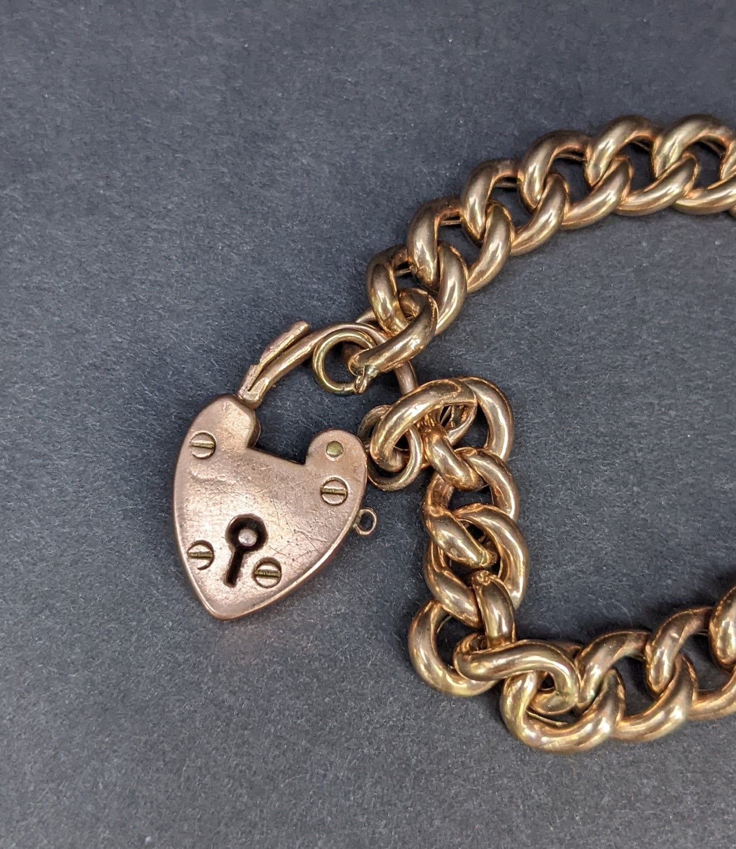 Heavy curb chain bracelet with heart padlock clasp