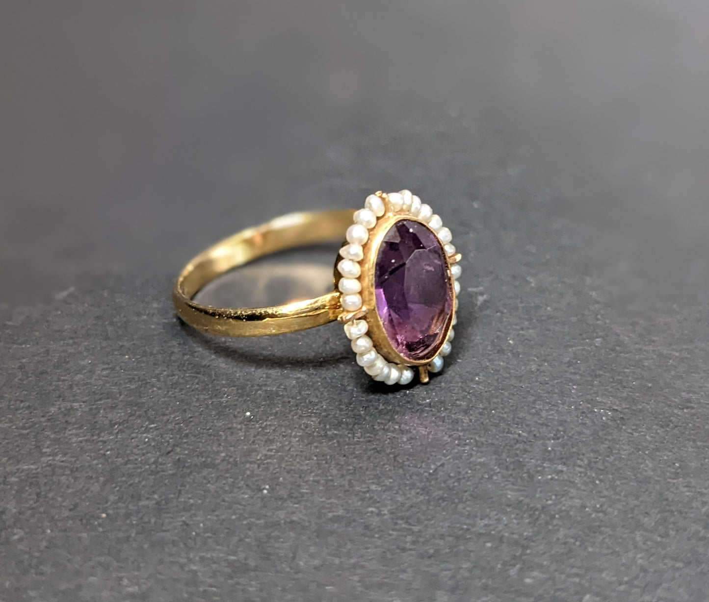 Wired seed pearls surrounding dark amethyst ring