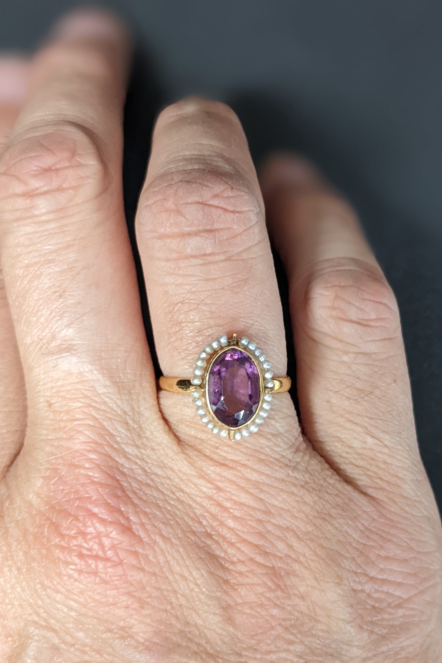 Wired seed pearls surrounding dark amethyst ring