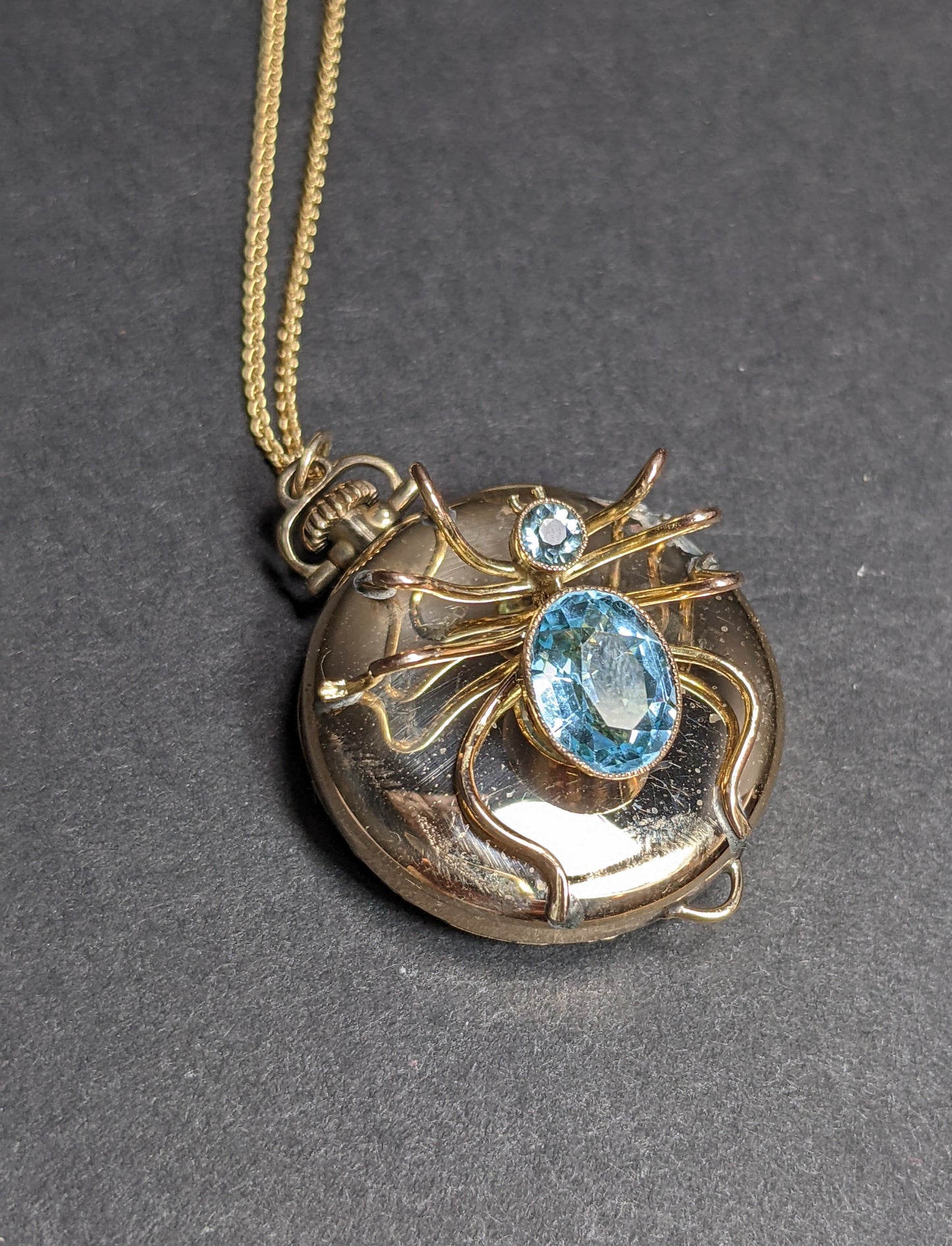 Spider on antique watch with gold chain